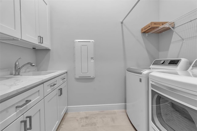 clothes washing area featuring cabinets, separate washer and dryer, and sink