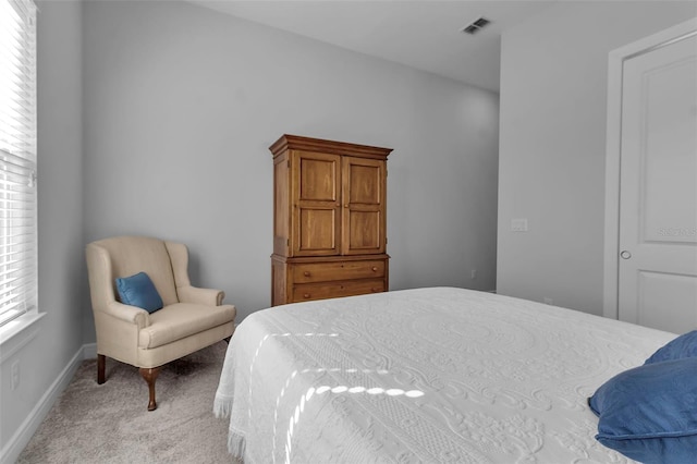 bedroom featuring light carpet