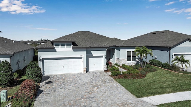 view of front facade with a garage and a front lawn