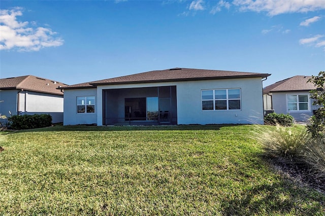 back of house with a lawn