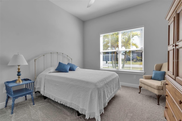 bedroom featuring ceiling fan and light carpet