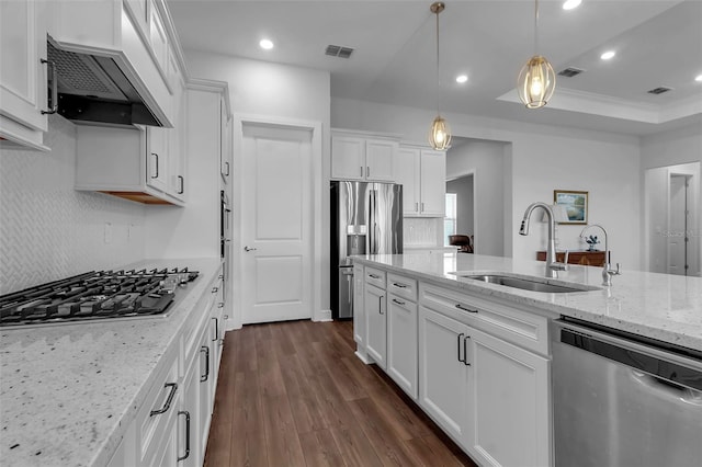 kitchen with sink, white cabinetry, stainless steel appliances, light stone countertops, and custom range hood