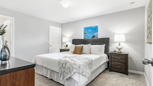 bedroom featuring baseboards and light colored carpet