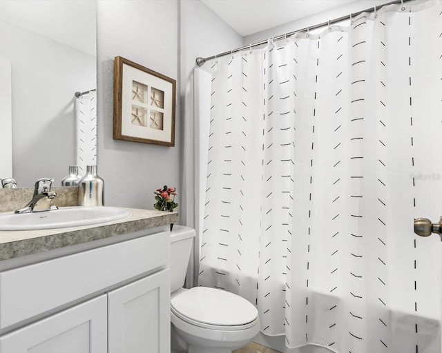 bathroom with toilet, shower / bath combo with shower curtain, and vanity