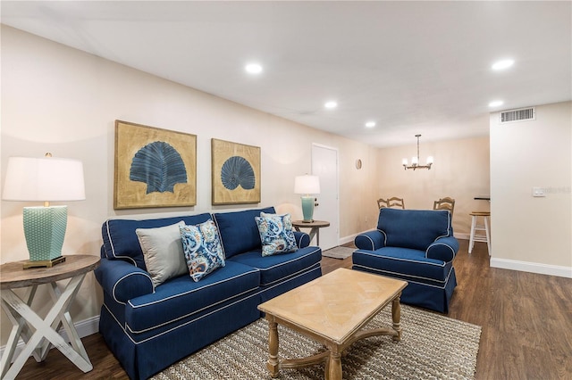 living room with an inviting chandelier and dark hardwood / wood-style flooring