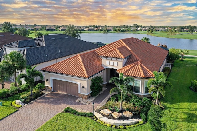 aerial view at dusk with a water view