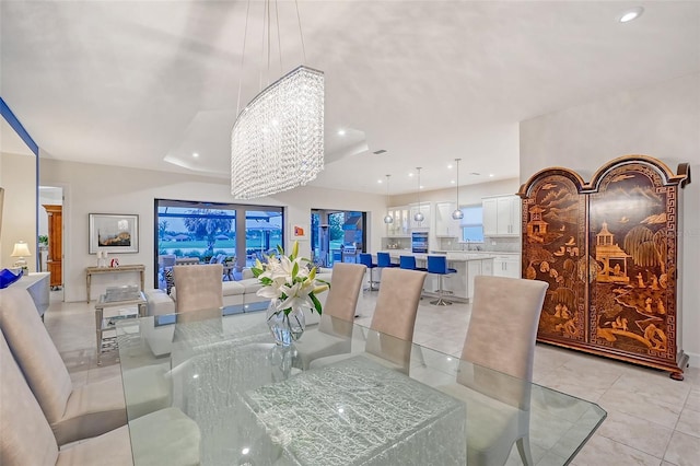 dining space featuring a chandelier and light tile patterned floors