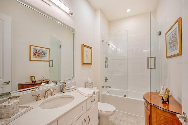 full bathroom with tile patterned flooring, vanity, bath / shower combo with glass door, and toilet