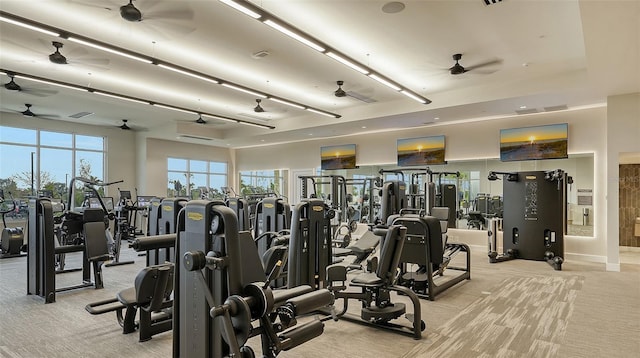 workout area featuring light carpet and ceiling fan