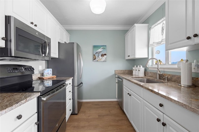 kitchen with sink, crown molding, stainless steel appliances, and white cabinets