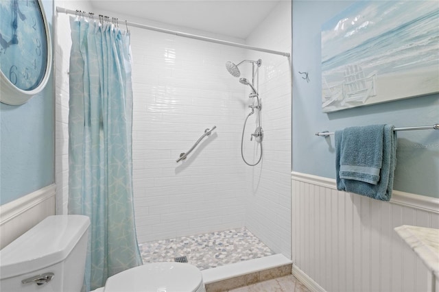 bathroom featuring toilet and a shower with shower curtain