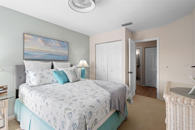 bedroom with light carpet and a closet