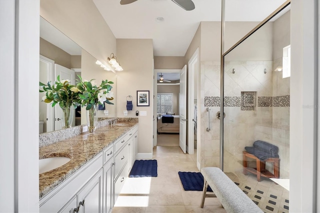 bathroom featuring ceiling fan, a tile shower, and vanity