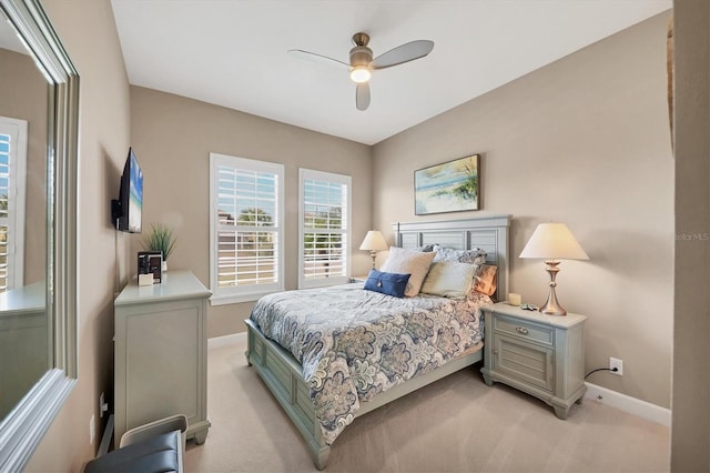 bedroom featuring ceiling fan and light carpet