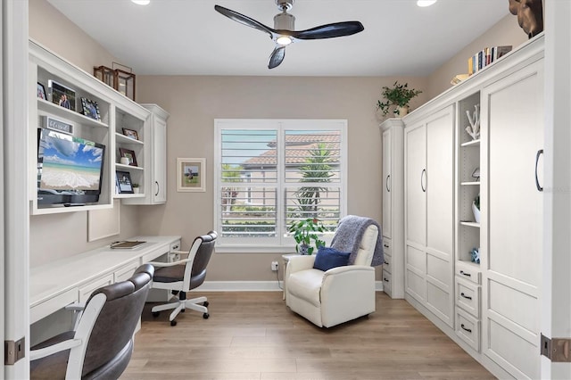 office area with ceiling fan, light hardwood / wood-style flooring, and built in desk