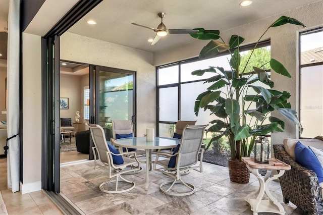 sunroom / solarium featuring ceiling fan