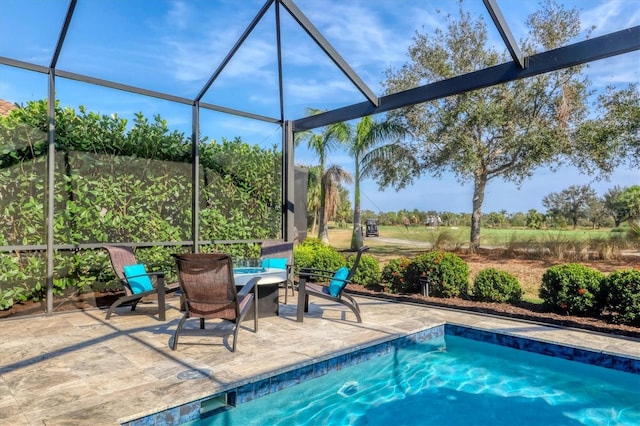 view of pool with a patio and a lanai