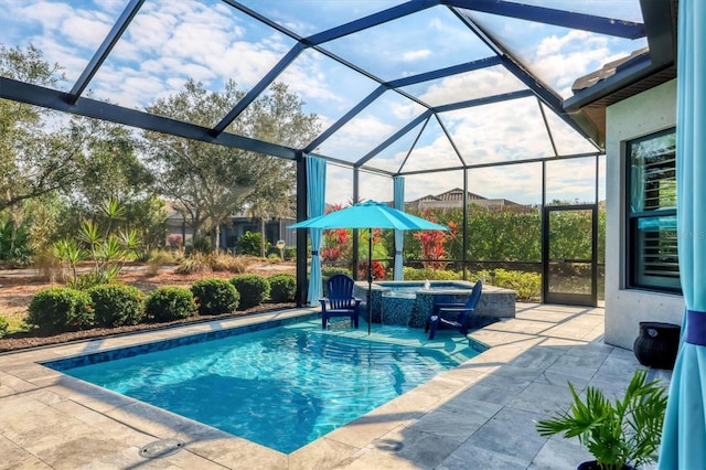 view of pool with a lanai, a patio area, and an in ground hot tub