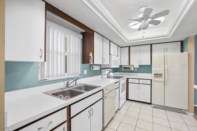 kitchen featuring light countertops, white appliances, a raised ceiling, and white cabinets