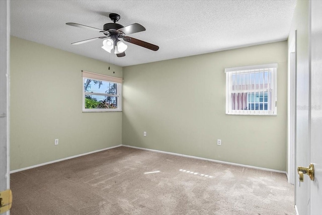 unfurnished bedroom featuring baseboards, a textured ceiling, and light colored carpet