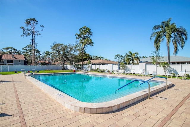 pool with a fenced backyard, a residential view, and a patio