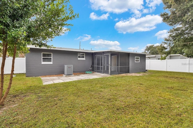 rear view of property with a patio, a sunroom, and a lawn