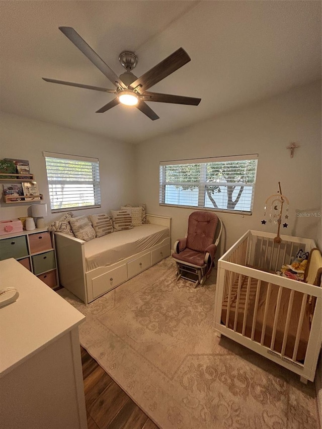 bedroom with lofted ceiling, hardwood / wood-style flooring, and ceiling fan