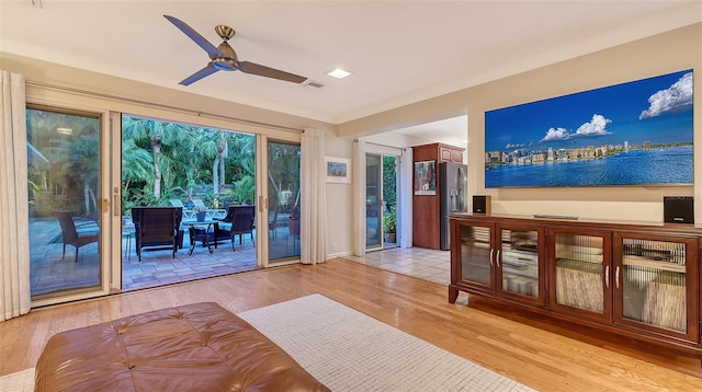 doorway with ceiling fan and light hardwood / wood-style floors