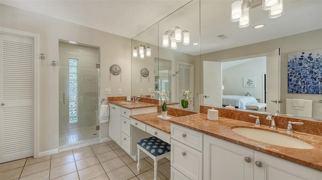 bathroom featuring tile patterned flooring, vanity, and an enclosed shower