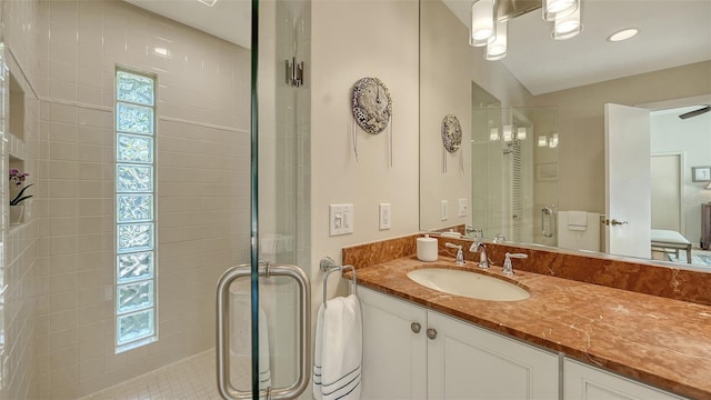 bathroom featuring vanity and an enclosed shower