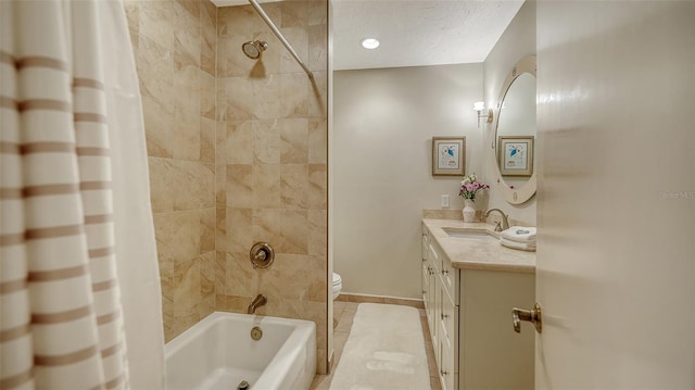 full bathroom featuring toilet, a textured ceiling, vanity, shower / bath combo with shower curtain, and tile patterned flooring