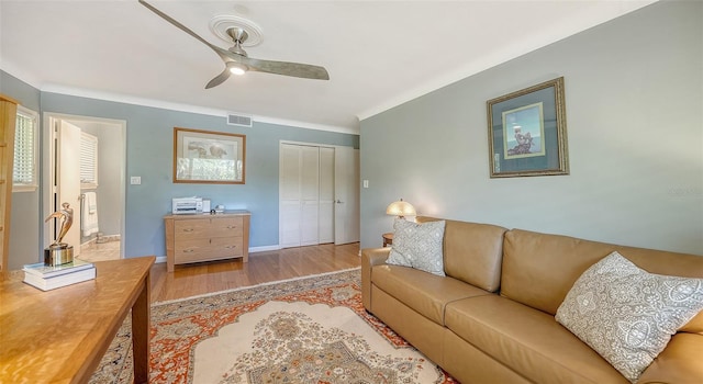 living room with ceiling fan and light wood-type flooring