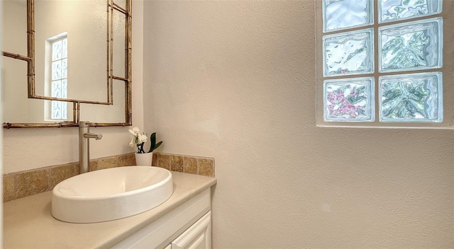 bathroom with vanity and plenty of natural light