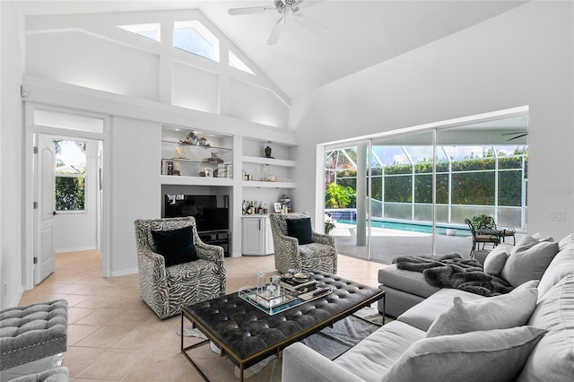 tiled living room featuring ceiling fan, high vaulted ceiling, and built in shelves