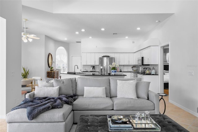 living room with light tile patterned floors and ceiling fan