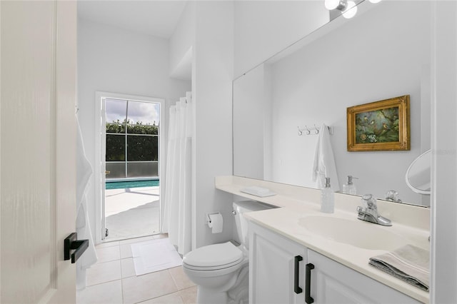 bathroom with vanity, toilet, and tile patterned flooring