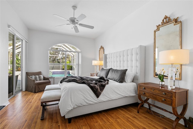 bedroom with hardwood / wood-style floors, access to outside, and ceiling fan