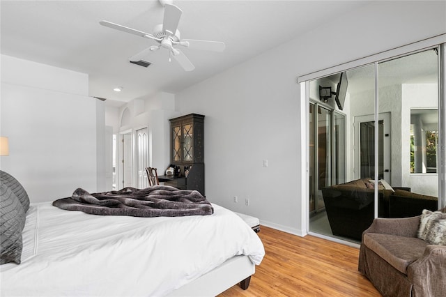 bedroom with light hardwood / wood-style floors and ceiling fan