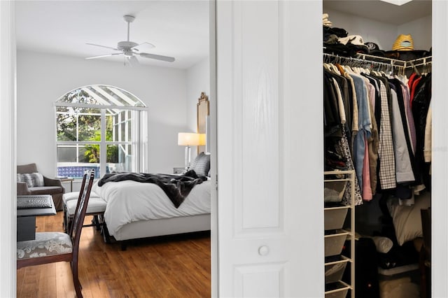 bedroom featuring hardwood / wood-style floors, a closet, and ceiling fan