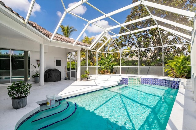 view of swimming pool with a lanai, area for grilling, pool water feature, and a patio area