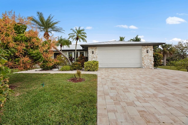 view of front of property with a garage and a front yard