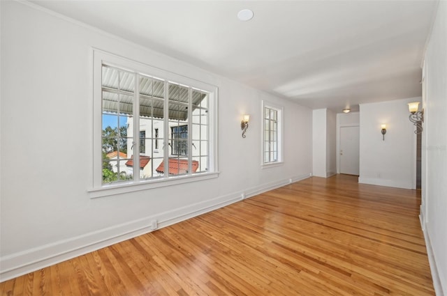 unfurnished room featuring light wood-style flooring and baseboards