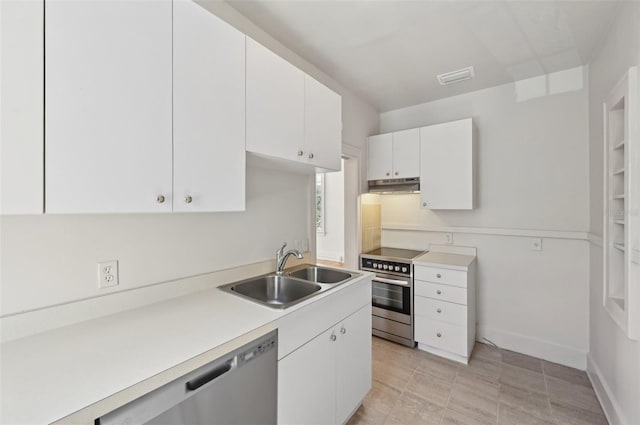 kitchen with under cabinet range hood, light countertops, white cabinets, stainless steel appliances, and a sink