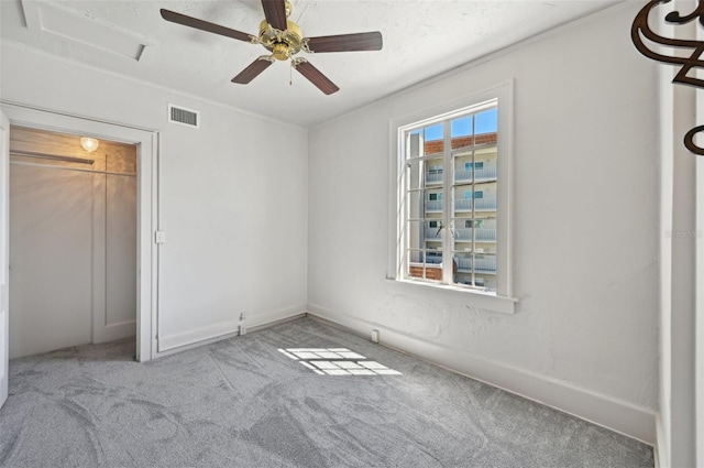 unfurnished bedroom with visible vents, ceiling fan, and carpet floors