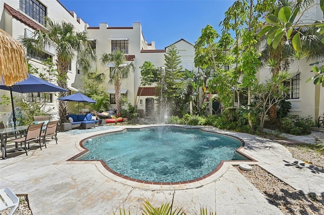 view of swimming pool with an outdoor living space and a patio