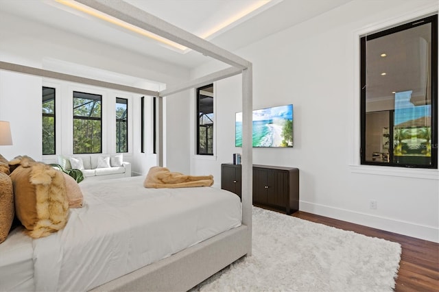 bedroom with dark hardwood / wood-style flooring