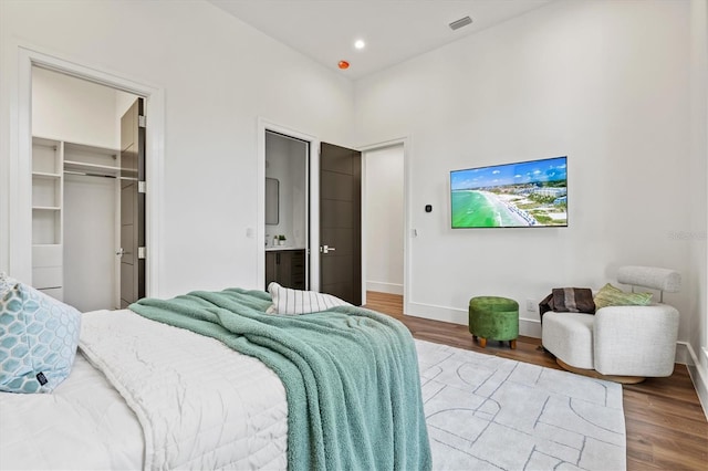 bedroom featuring hardwood / wood-style floors and a spacious closet