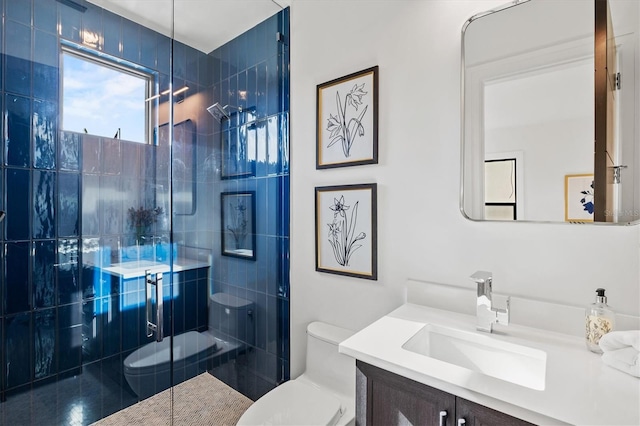 bathroom featuring vanity, toilet, and a shower with door