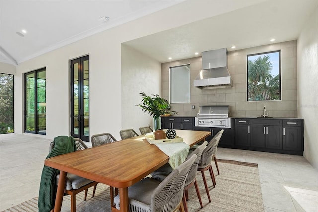 tiled dining area featuring crown molding and sink