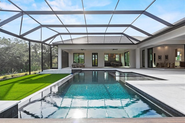 view of pool featuring ceiling fan, a yard, a lanai, and a patio area